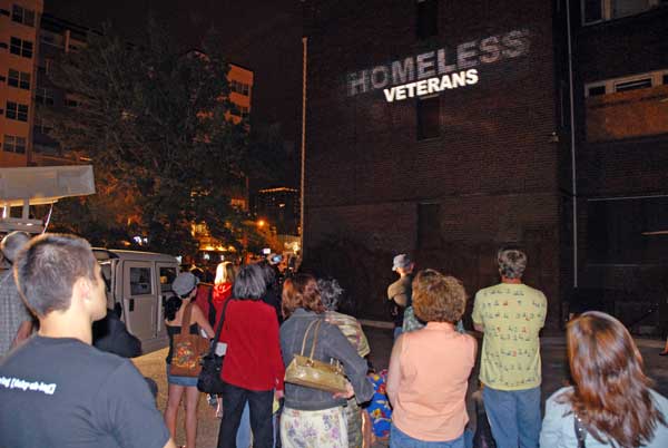 The words of the veterans being shot onto the wall of a homeless shelter